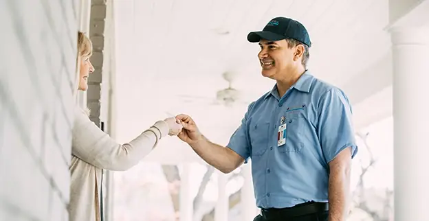 HVAC comfort advisor shaking hands with a homeowner at the front door